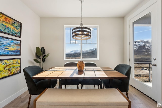 6005 N Westridge Rd, Heber City, UT 84032 - dining room featuring light wood-style floors, a notable chandelier, and plenty of natural light