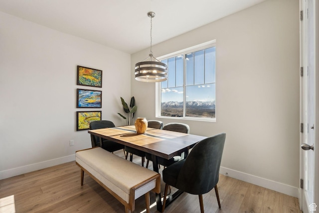 6005 N Westridge Rd, Heber City, UT 84032 - dining area with baseboards, light wood-style floors, and a notable chandelier