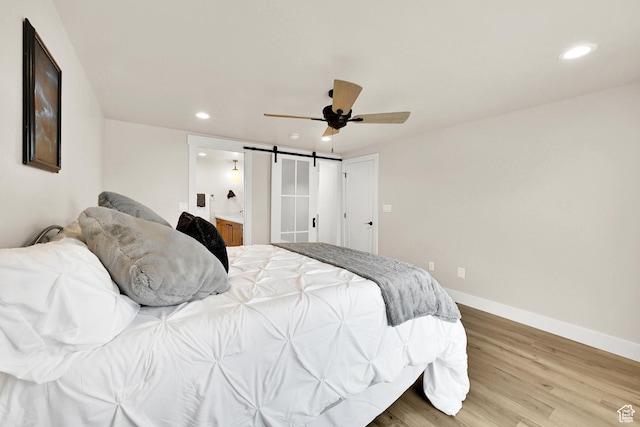 bedroom with light wood-style flooring, baseboards, ceiling fan, connected bathroom, and recessed lighting