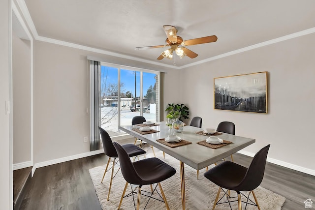 dining room with baseboards, dark wood-style flooring, crown molding, and a ceiling fan