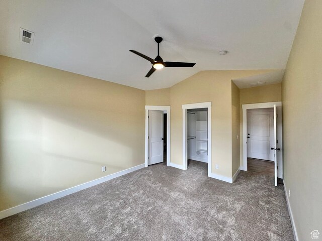 18136 N 6000 W, Garland, UT 84312 - unfurnished bedroom with visible vents, a walk in closet, baseboards, carpet flooring, and lofted ceiling