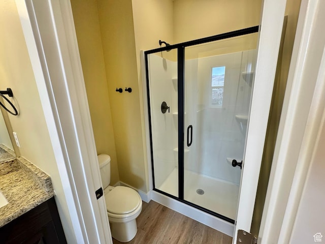 18136 N 6000 W, Garland, UT 84312 - bathroom with a stall shower, toilet, and wood finished floors