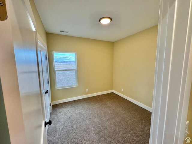 18136 N 6000 W, Garland, UT 84312 - empty room with baseboards, visible vents, and dark colored carpet
