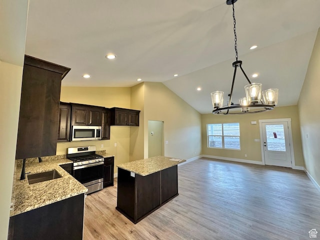 18136 N 6000 W, Garland, UT 84312 - kitchen featuring an inviting chandelier, a sink, stainless steel appliances, dark brown cabinetry, and a center island