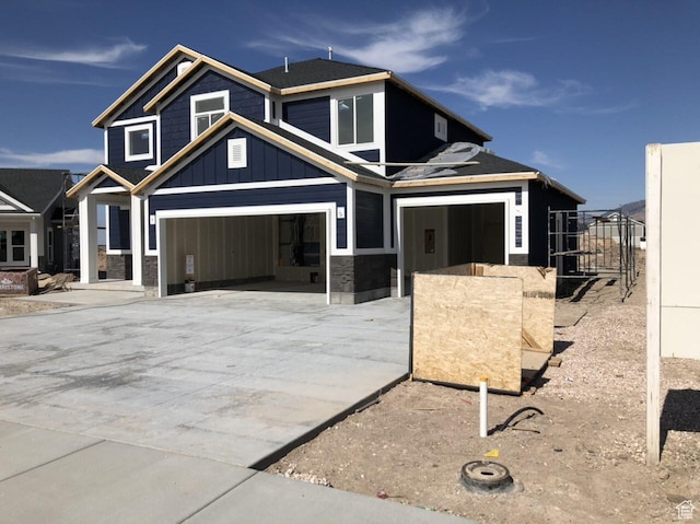 3999 W 2025 S Unit 45, Taylor, UT 84401 - view of front of property with board and batten siding, concrete driveway, and an attached garage
