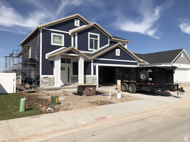 3999 W 2025 S Unit 45, Taylor, UT 84401 - view of front of home featuring stone siding, board and batten siding, and driveway