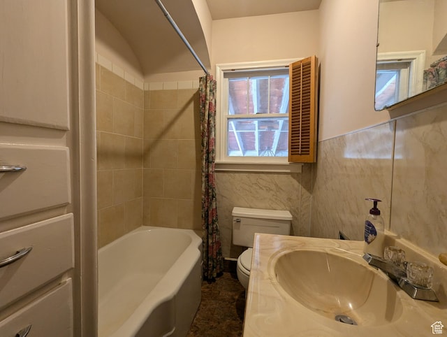 bathroom featuring shower / bathtub combination with curtain, toilet, tile walls, wainscoting, and vanity