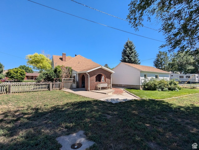 back of house with a yard, a patio area, a chimney, and fence