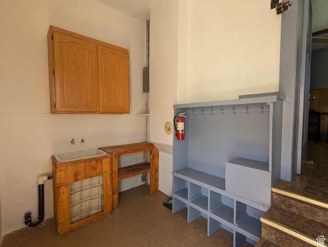 misc room featuring finished concrete floors and a sink