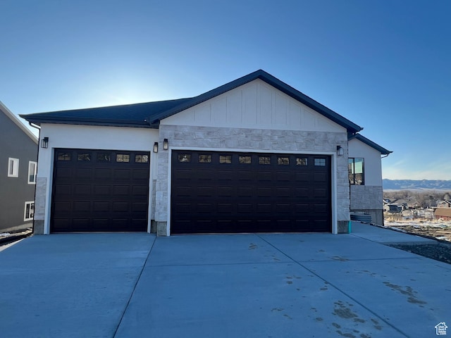 572 S 600 E Unit 2, Nephi, UT 84648 - view of front facade with board and batten siding, concrete driveway, a garage, and stone siding