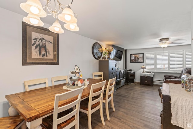 dining space with a baseboard heating unit, dark wood-type flooring, and ceiling fan with notable chandelier