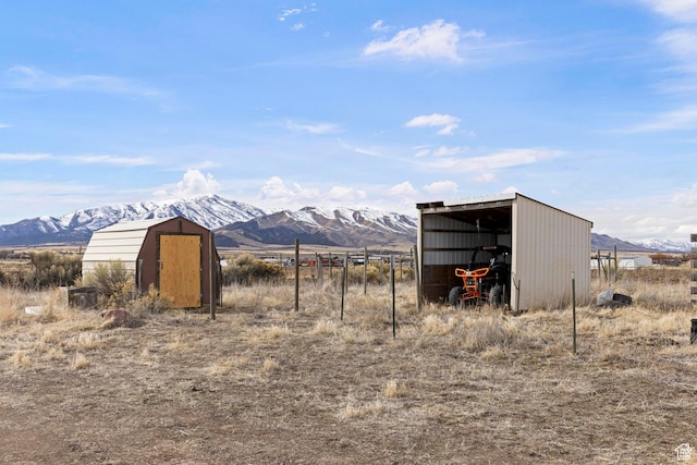 view of pole building featuring a mountain view and a shed