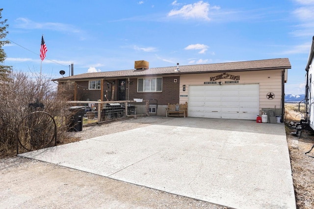 ranch-style house with an attached garage and driveway