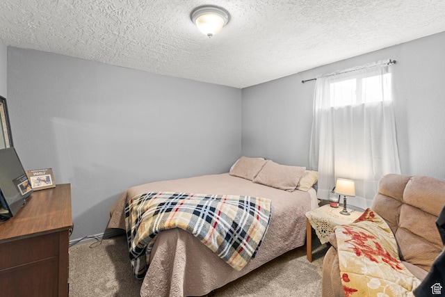 bedroom with a textured ceiling and carpet