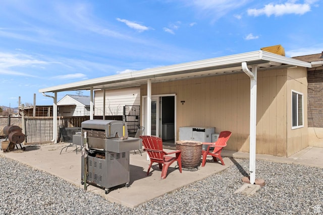 view of patio / terrace with a grill, a fire pit, and fence