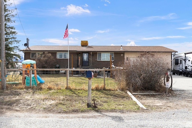 back of property featuring brick siding and fence