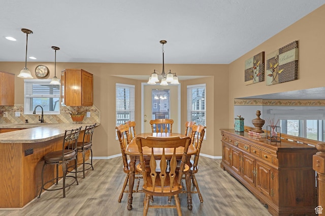 1778 Allison Way, Syracuse, UT 84075 - dining room with an inviting chandelier, baseboards, light wood-style floors, and recessed lighting