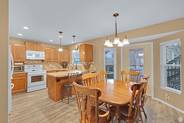1778 Allison Way, Syracuse, UT 84075 - dining area with an inviting chandelier, recessed lighting, baseboards, and light wood-type flooring