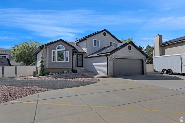 1778 Allison Way, Syracuse, UT 84075 - traditional home featuring a garage, fence, cooling unit, roof mounted solar panels, and driveway