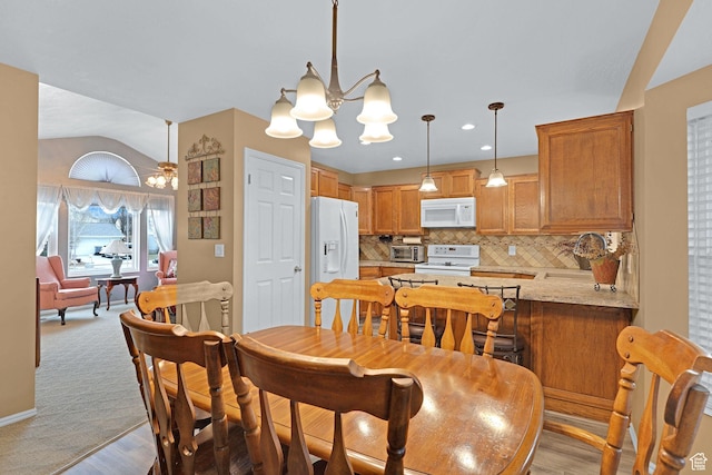 1778 Allison Way, Syracuse, UT 84075 - dining space with a toaster, baseboards, lofted ceiling, an inviting chandelier, and light wood-style flooring