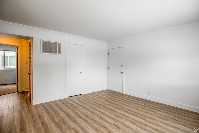 720 E 5th Ave N Unit 9, Salt Lake City, UT 84103 - unfurnished bedroom featuring crown molding, wood finished floors, visible vents, and baseboards