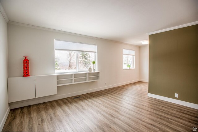 720 E 5th Ave N Unit 9, Salt Lake City, UT 84103 - unfurnished room with baseboards, wood finished floors, and ornamental molding