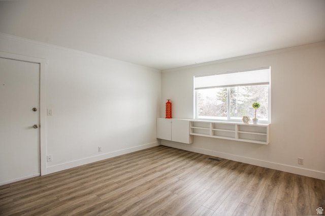 720 E 5th Ave N Unit 9, Salt Lake City, UT 84103 - empty room featuring ornamental molding, baseboards, and wood finished floors