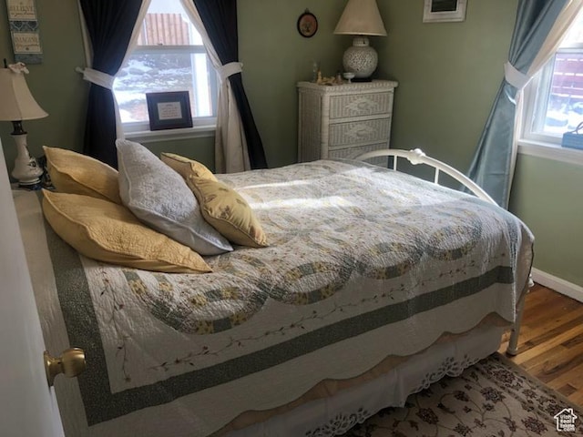 3614 Taylor Ave, Ogden, UT 84403 - bedroom with baseboards, wood finished floors, and multiple windows