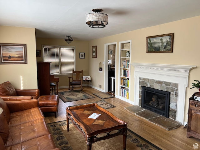 3614 Taylor Ave, Ogden, UT 84403 - living room with wood finished floors, baseboards, and a stone fireplace
