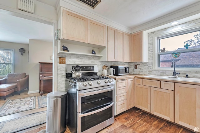 3614 Taylor Ave, Ogden, UT 84403 - kitchen with light brown cabinetry, range with two ovens, a sink, and wood finished floors