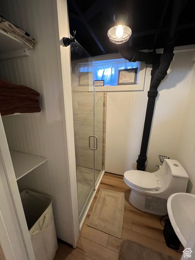 3614 Taylor Ave, Ogden, UT 84403 - full bathroom featuring wood finished floors, toilet, a stall shower, and a sink