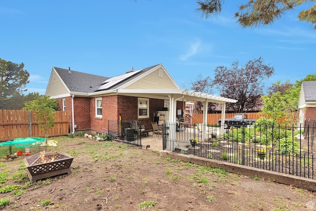 3614 Taylor Ave, Ogden, UT 84403 - back of property with a fire pit, a patio, brick siding, a fenced backyard, and roof with shingles