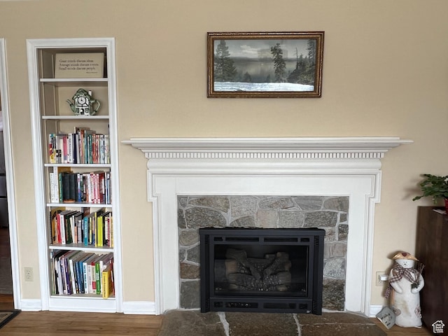 3614 Taylor Ave, Ogden, UT 84403 - interior details with a stone fireplace, built in features, baseboards, and wood finished floors