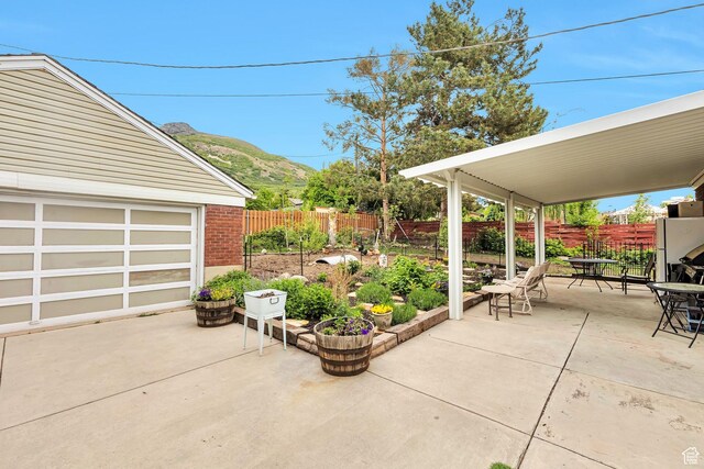 3614 Taylor Ave, Ogden, UT 84403 - fenced backyard featuring a patio, outdoor dining space, and a mountain view