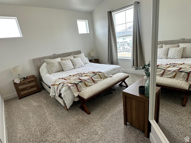 938 W Coral Charm Way N Unit L302, Saratoga Springs, UT 84045 - bedroom with baseboards, lofted ceiling, and light carpet