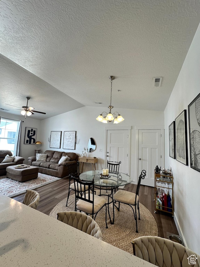 938 W Coral Charm Way N Unit L302, Saratoga Springs, UT 84045 - living area featuring visible vents, ceiling fan with notable chandelier, dark wood finished floors, and vaulted ceiling