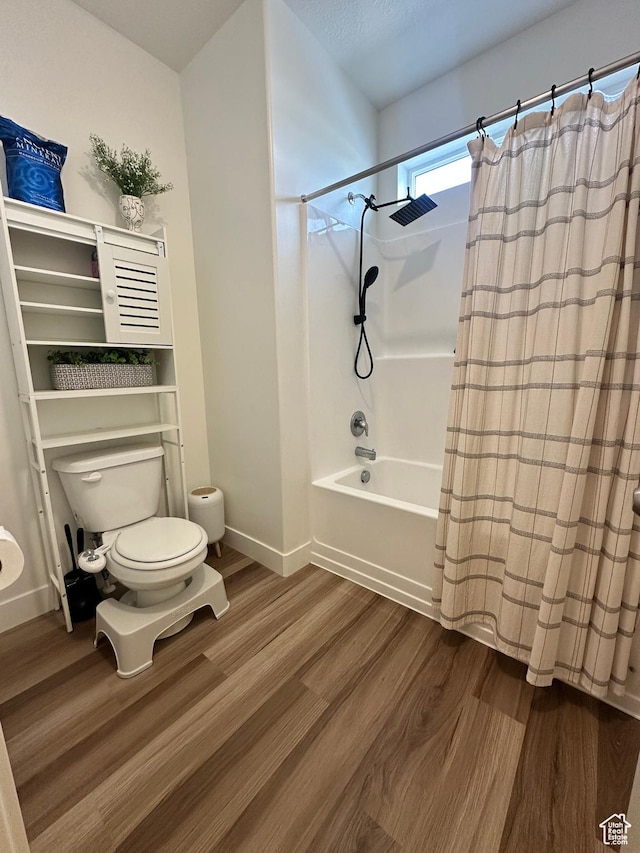 938 W Coral Charm Way N Unit L302, Saratoga Springs, UT 84045 - bathroom with shower / tub combo, toilet, wood finished floors, and baseboards
