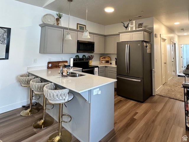 938 W Coral Charm Way N Unit L302, Saratoga Springs, UT 84045 - kitchen featuring a sink, stainless steel microwave, electric range oven, freestanding refrigerator, and a peninsula