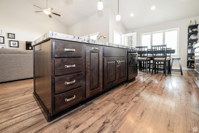 2252 W 3250 S, West Haven, UT 84401 - kitchen with open floor plan, dark brown cabinetry, a ceiling fan, wood finished floors, and decorative light fixtures