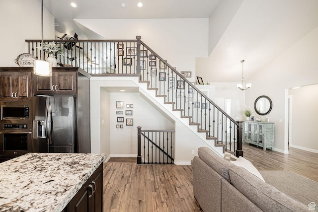 2252 W 3250 S, West Haven, UT 84401 - interior space featuring high vaulted ceiling, dark brown cabinetry, appliances with stainless steel finishes, and wood finished floors