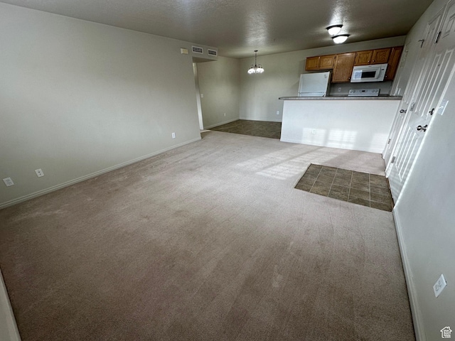 1219 S 1850 W Unit 223, Springville, UT 84663 - unfurnished living room featuring visible vents, a notable chandelier, carpet, and baseboards