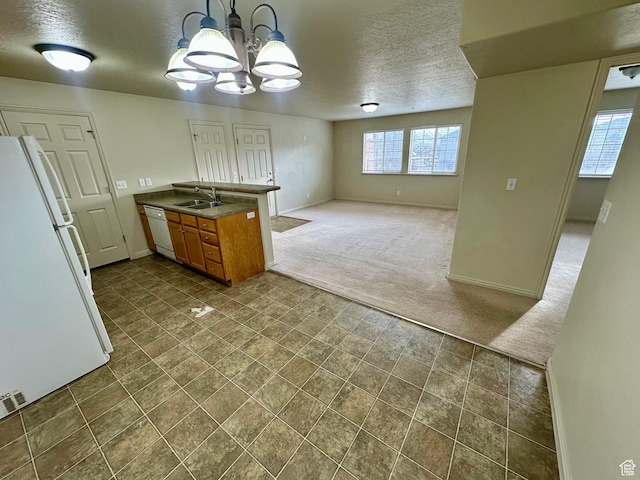 1219 S 1850 W Unit 223, Springville, UT 84663 - kitchen with a sink, dark carpet, white appliances, a peninsula, and brown cabinetry
