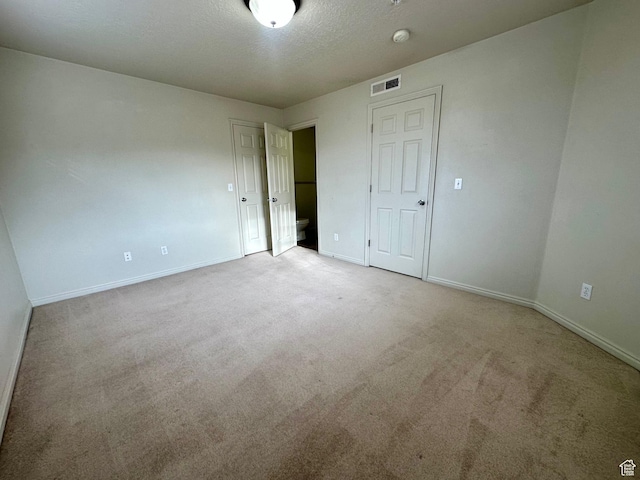 1219 S 1850 W Unit 223, Springville, UT 84663 - unfurnished bedroom featuring carpet flooring, baseboards, visible vents, and a textured ceiling