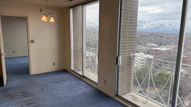 777 E S Temple Unit 13A, Salt Lake City, UT 84102 - unfurnished dining area with carpet floors, a mountain view, a chandelier, and healthy amount of natural light
