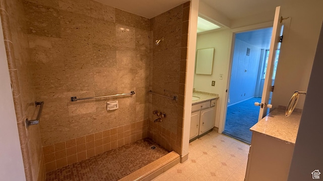 777 E S Temple Unit 13A, Salt Lake City, UT 84102 - bathroom featuring vanity, a tile shower, and tile patterned floors
