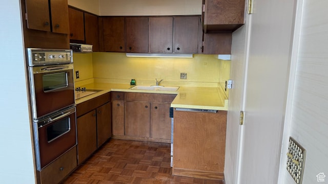 777 E S Temple Unit 13A, Salt Lake City, UT 84102 - kitchen featuring a sink, light countertops, black electric stovetop, and multiple ovens