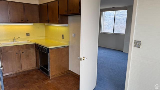 777 E S Temple Unit 13A, Salt Lake City, UT 84102 - kitchen with black dishwasher, a sink, light countertops, and baseboards