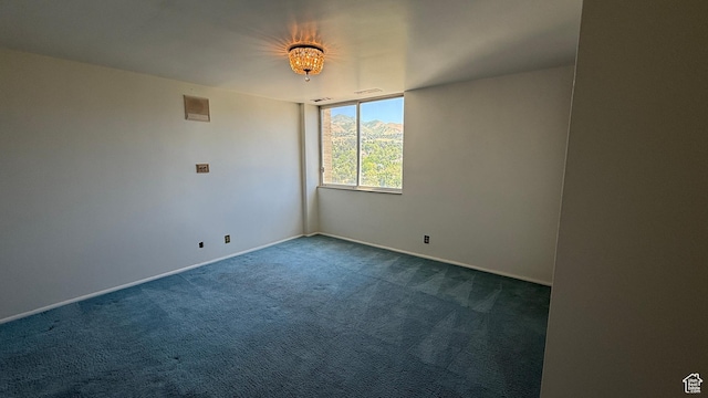 777 E S Temple Unit 13A, Salt Lake City, UT 84102 - unfurnished room with dark carpet and baseboards