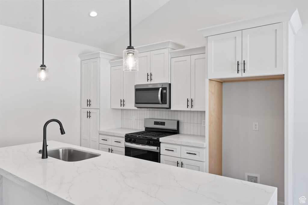 5336 S Murray Rd Unit 115, Murray, UT 84123 - kitchen featuring a sink, backsplash, white cabinetry, and stainless steel appliances