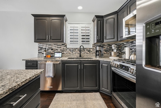 10358 N Tamarack Way E, Cedar Hills, UT 84062 - kitchen with appliances with stainless steel finishes, backsplash, dark wood-style flooring, light stone counters, and recessed lighting